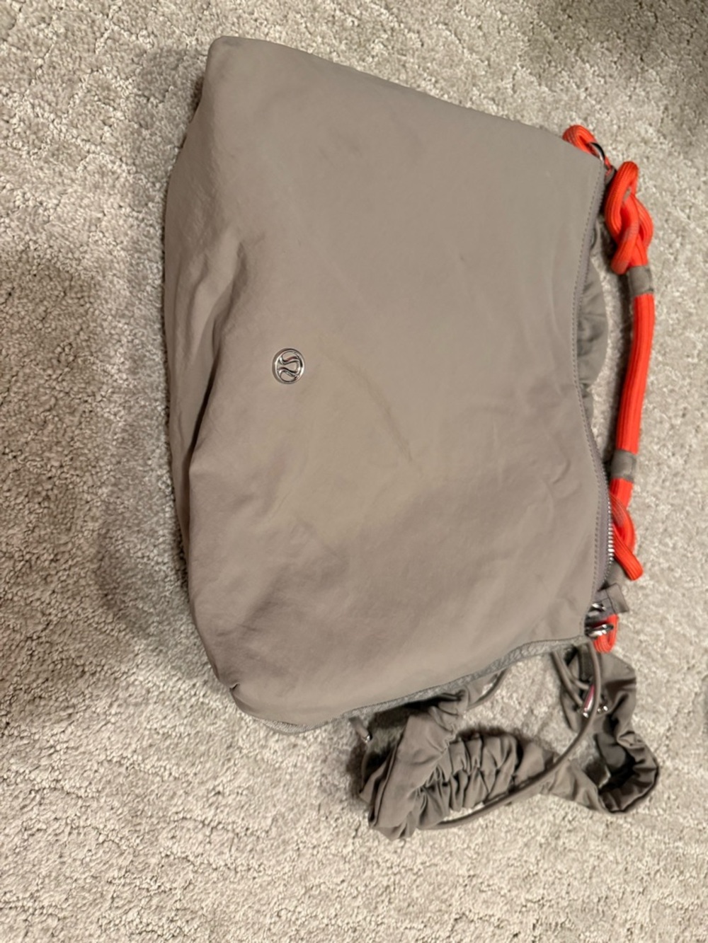 lululemon athletica taupe crossbody with bright orange cord detail